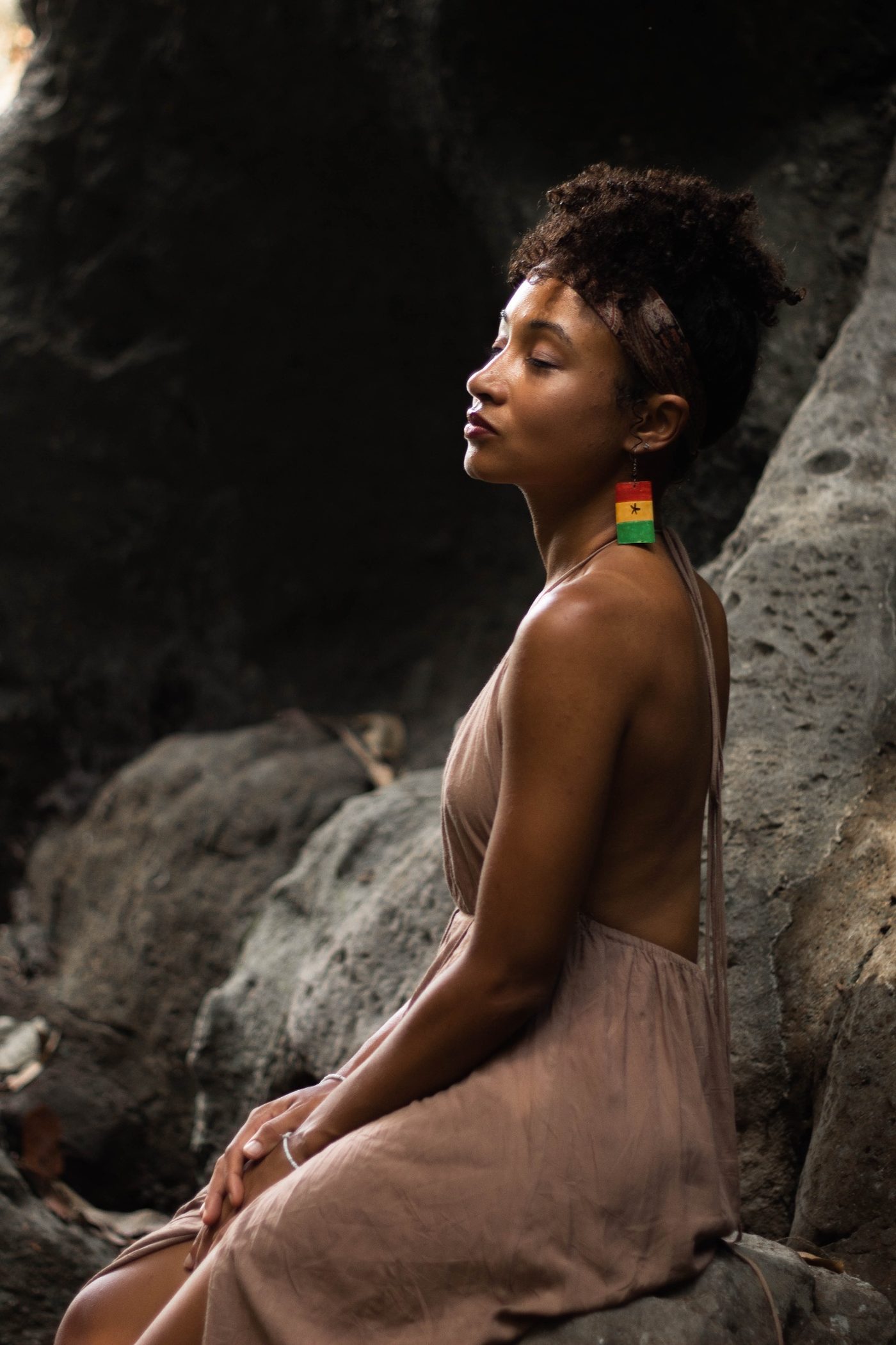 Portrait of a woman seated in quiet reflection among rocks